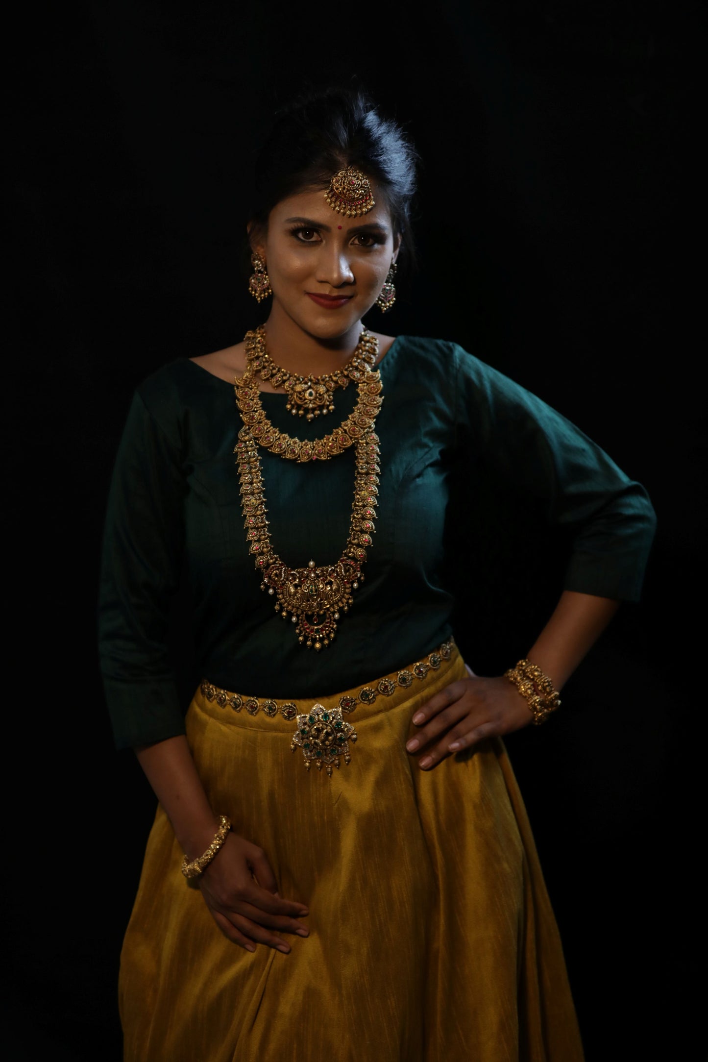 Dark green full sleeves blouse and beige color lehenga